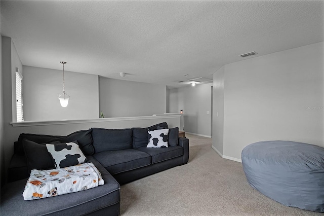 carpeted living room featuring a textured ceiling