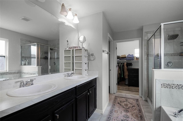 bathroom featuring a shower with door, vanity, and tile patterned flooring