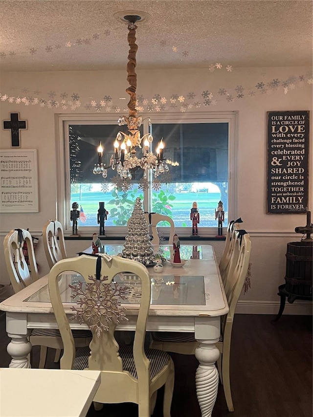 dining space with a wealth of natural light, an inviting chandelier, and a textured ceiling