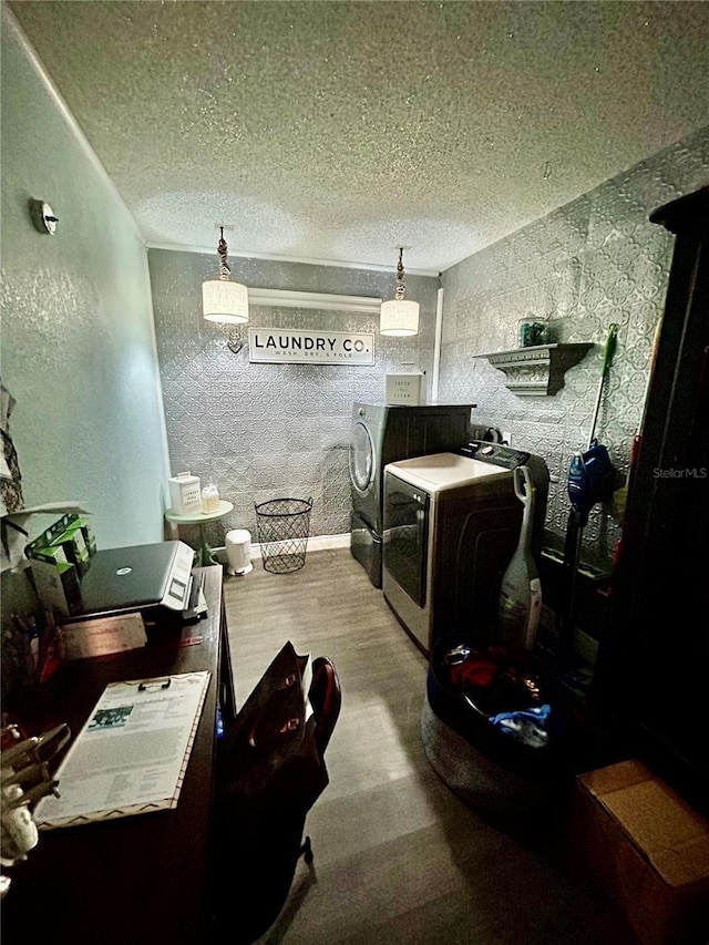 interior space featuring hardwood / wood-style flooring, independent washer and dryer, and a textured ceiling