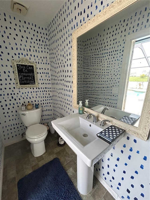 bathroom with tile patterned flooring, sink, and toilet