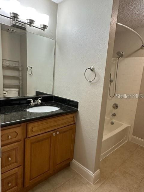 bathroom with shower / bathtub combination, a textured ceiling, vanity, and tile patterned flooring