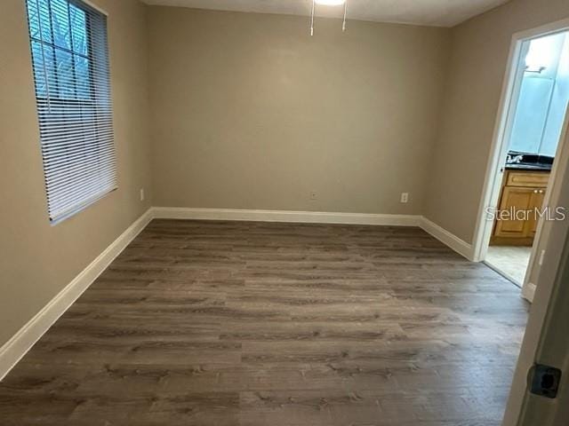 unfurnished room with dark hardwood / wood-style floors