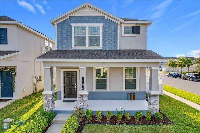 view of front of property featuring a porch and a front yard