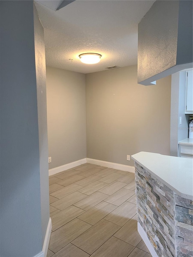 interior space featuring a textured ceiling