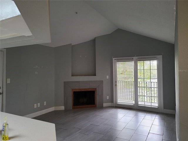 unfurnished living room with a fireplace and vaulted ceiling