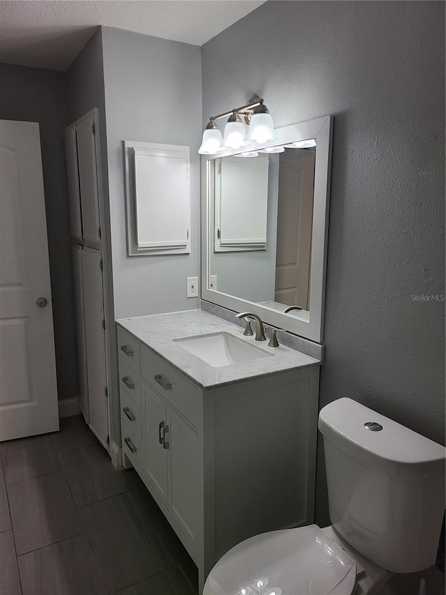 bathroom featuring vanity and toilet