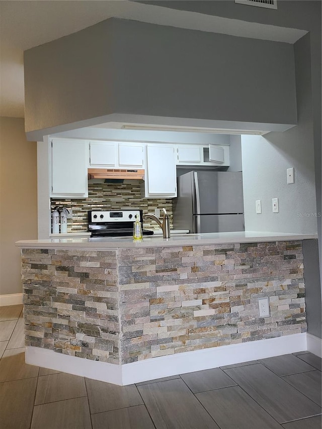 kitchen with sink, white cabinets, tasteful backsplash, and appliances with stainless steel finishes