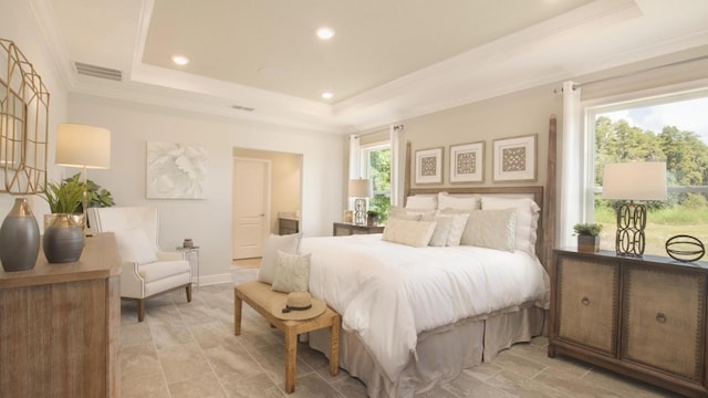 bedroom with a tray ceiling and ornamental molding