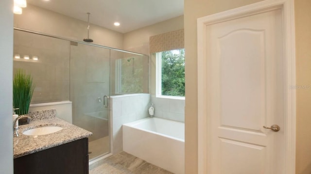 bathroom with tile patterned floors, vanity, and separate shower and tub