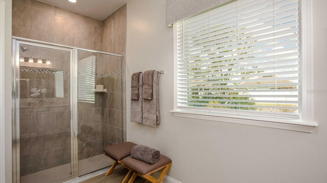 bathroom with a shower with shower door