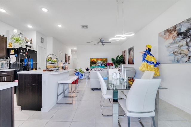 dining room with ceiling fan and light tile patterned flooring