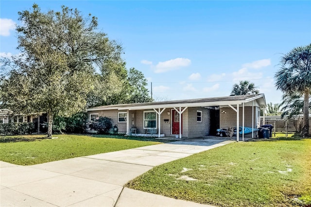 ranch-style house featuring a carport and a front lawn