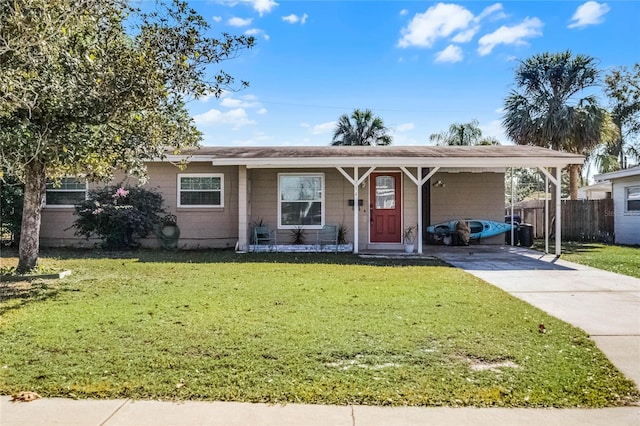 view of front of property with a carport and a front yard