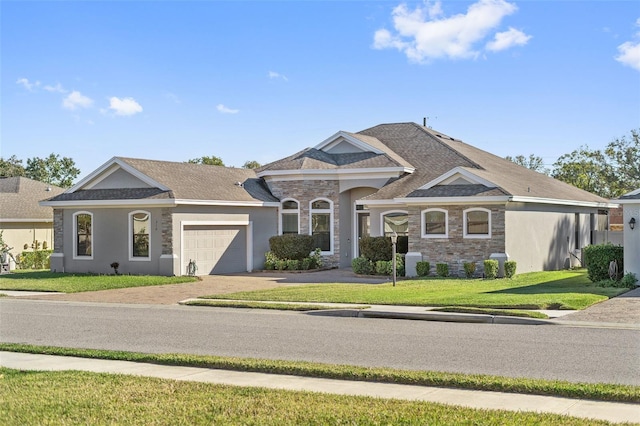 view of front of house featuring a garage and a front lawn