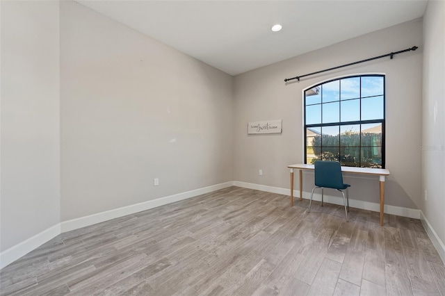 unfurnished office featuring light wood-type flooring