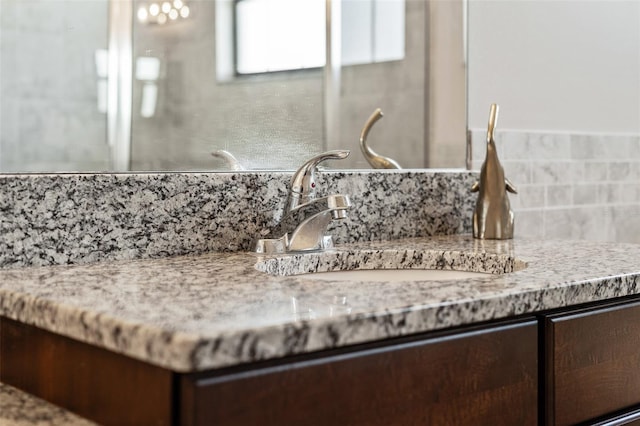 details featuring tasteful backsplash and sink