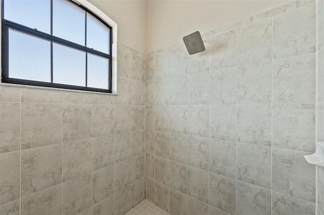 bathroom with tiled shower