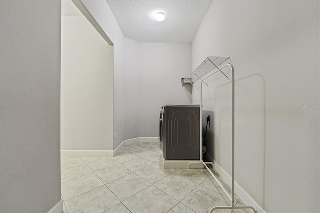 washroom with hookup for an electric dryer and light tile patterned flooring