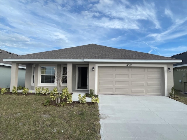 ranch-style house featuring a front lawn and a garage