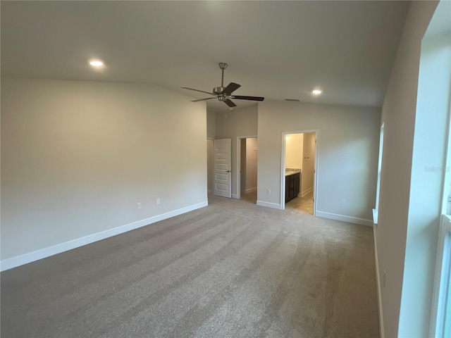 carpeted spare room with vaulted ceiling and ceiling fan