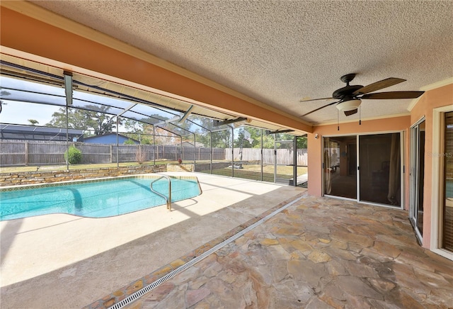 view of swimming pool featuring a lanai, ceiling fan, and a patio area