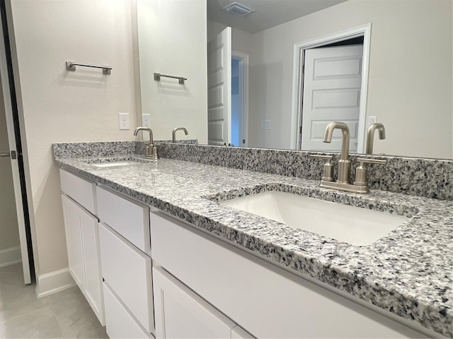 bathroom featuring tile patterned floors and vanity