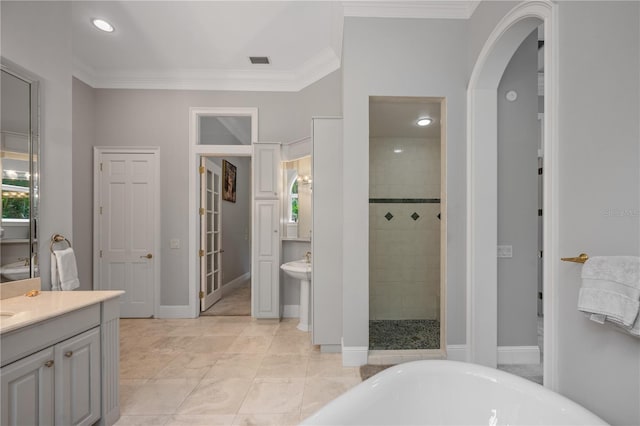 bathroom with tile patterned flooring, vanity, crown molding, and plus walk in shower