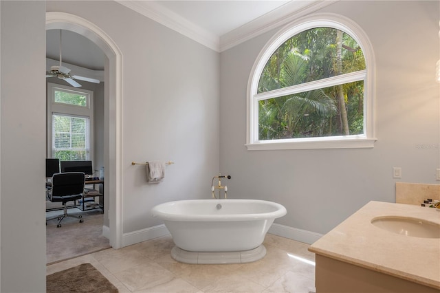 bathroom with ceiling fan, vanity, tile patterned flooring, ornamental molding, and a bathtub