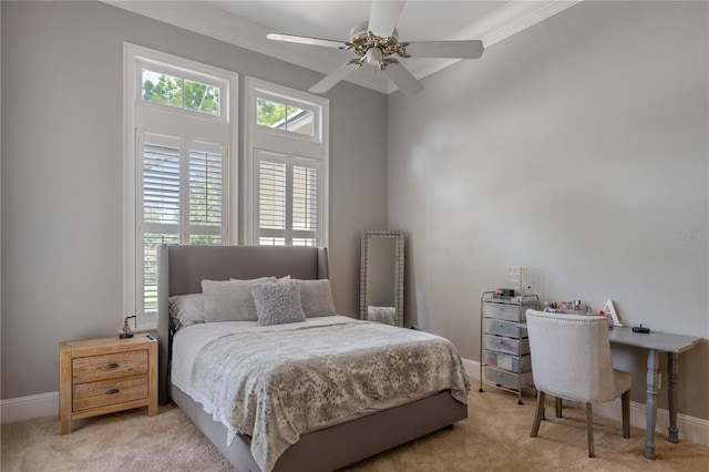 carpeted bedroom with ceiling fan and ornamental molding