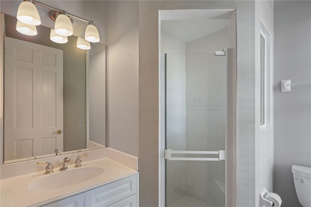 bathroom with an enclosed shower, vanity, and toilet