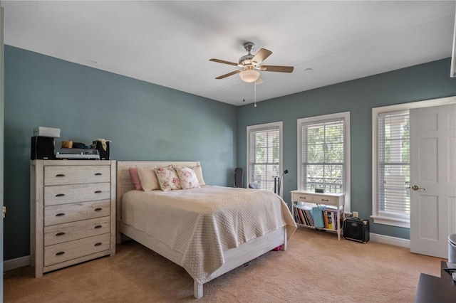 bedroom with ceiling fan and light carpet