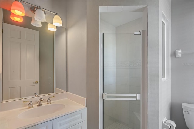 bathroom with walk in shower, vanity, and toilet