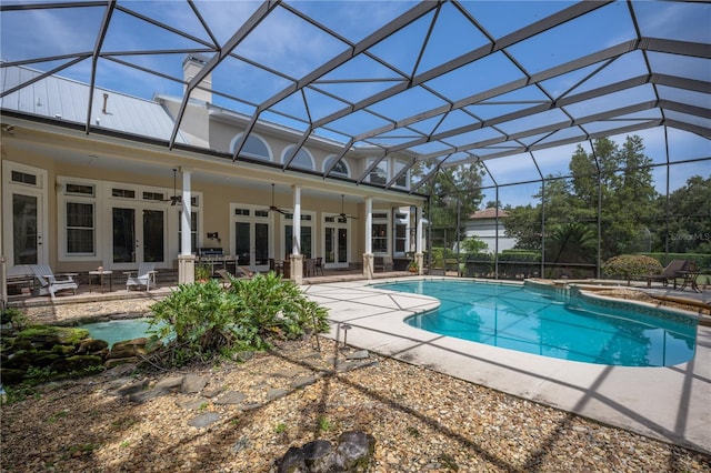 view of swimming pool featuring ceiling fan, french doors, a patio, and glass enclosure