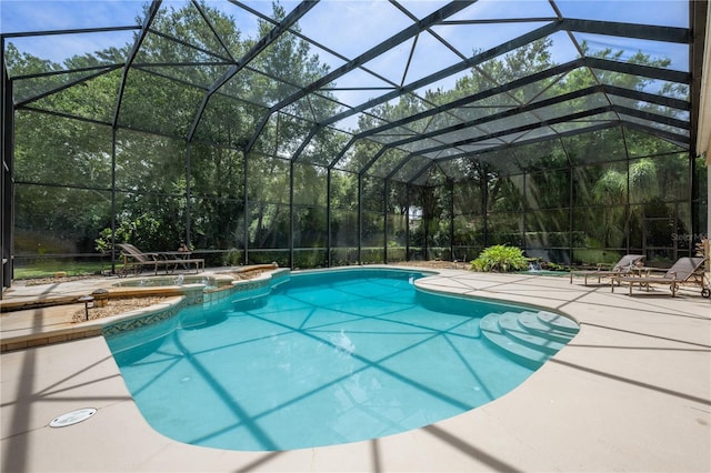 view of pool with glass enclosure and a patio area