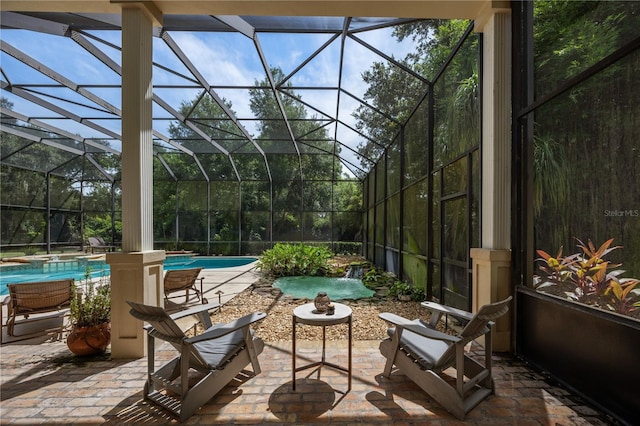 view of patio with pool water feature and glass enclosure