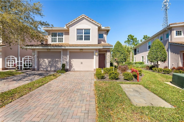 view of front facade featuring a garage and a front lawn