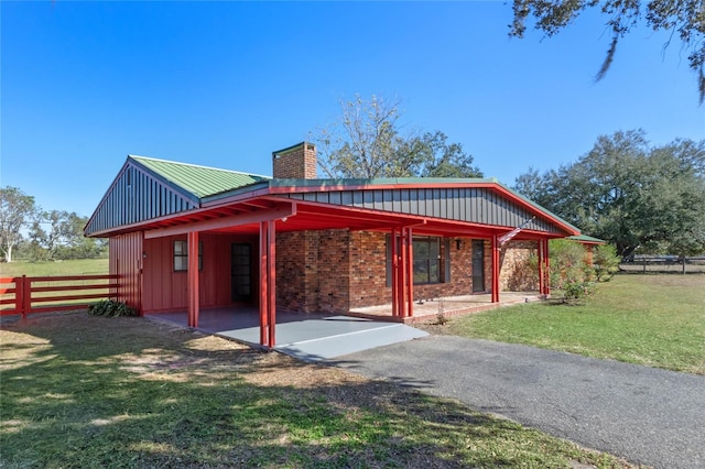 back of property with a lawn