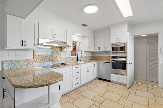 kitchen with white cabinetry, sink, light stone counters, stainless steel appliances, and crown molding