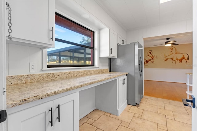 kitchen featuring stainless steel refrigerator with ice dispenser, crown molding, light stone countertops, and white cabinets