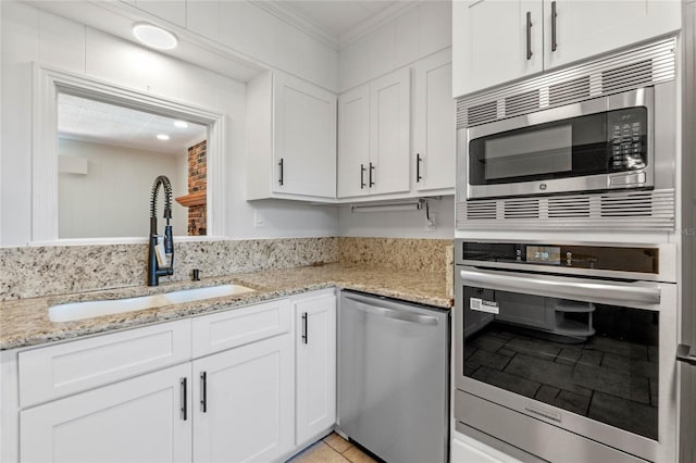 kitchen with sink, crown molding, white cabinets, and appliances with stainless steel finishes