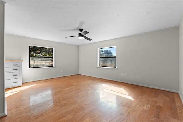 empty room with light hardwood / wood-style flooring and ceiling fan