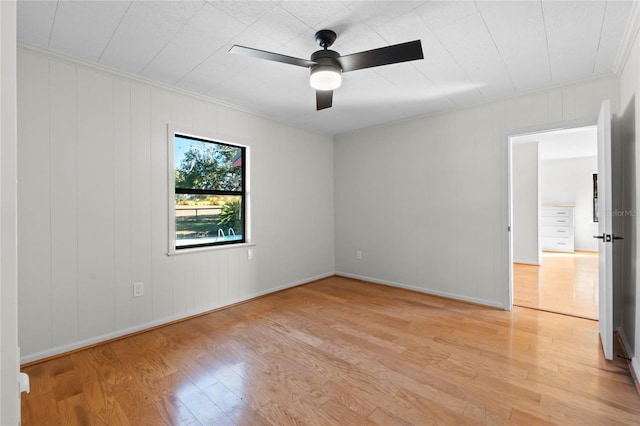 unfurnished room featuring ceiling fan, ornamental molding, and light wood-type flooring