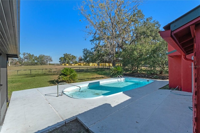 view of pool with a yard and a patio