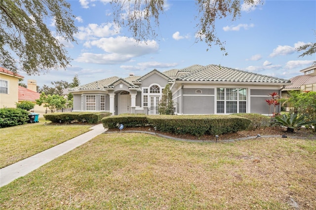 mediterranean / spanish-style house featuring a front lawn