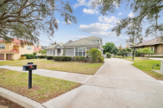 mediterranean / spanish-style home with a front yard