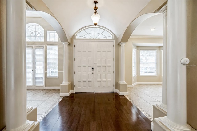 foyer with decorative columns, plenty of natural light, and hardwood / wood-style flooring