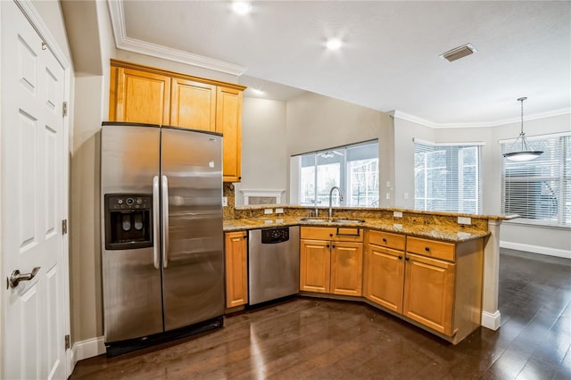 kitchen with light stone countertops, sink, kitchen peninsula, and stainless steel appliances