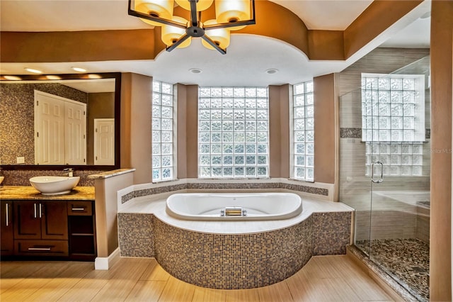 bathroom with vanity and separate shower and tub