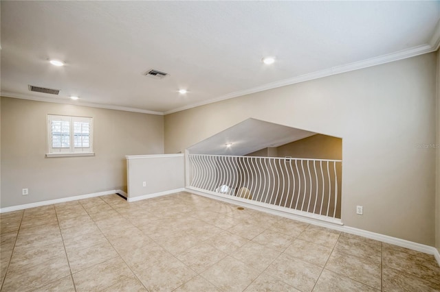 basement featuring ornamental molding and light tile patterned flooring